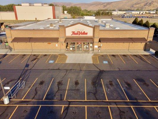 Aerial view of building and parking lot after hours.