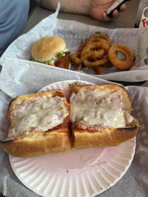 Meatball submarine sandwich, bacon burger, onion rings