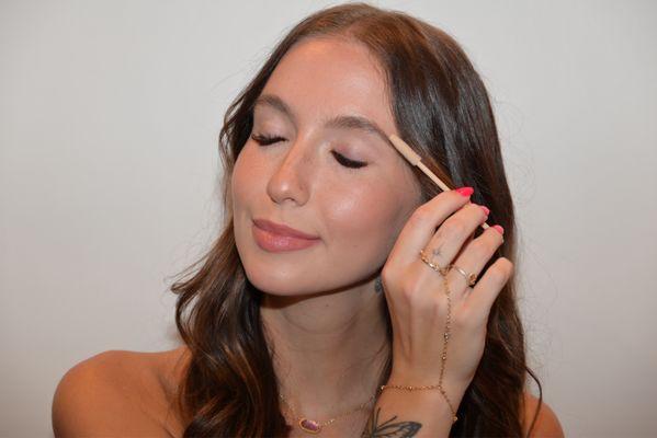 Brushing Lash extensions with a spoolie