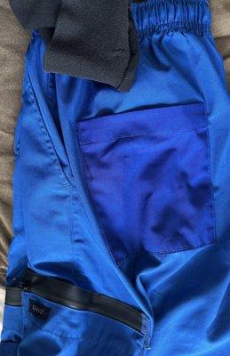New blue scrub butt pocket and water resistant zippers added to big side pockets. Black scrub pants had a hole on the ankle cuff fixed.