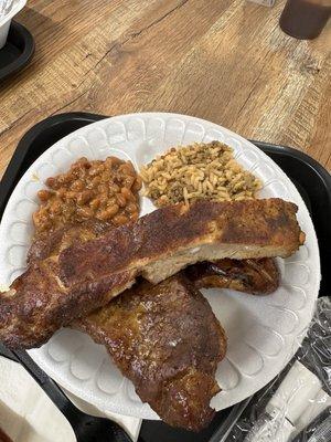 Pork Steak, rib, baked beans, and dirty rice