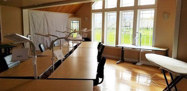 Tables set up in the great room area with lots of natural light and space for everyone and the craft they are working on!