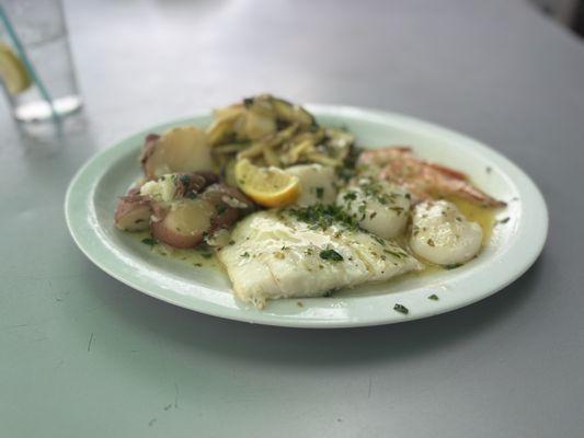 Broiled seafood with lemon butter and parsley