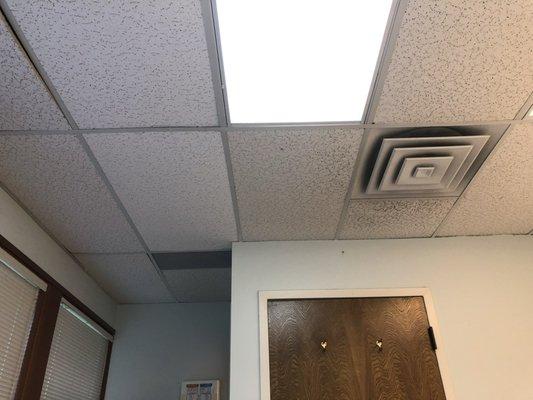 Exam room ambiance is affected by ceiling tiles and lights.