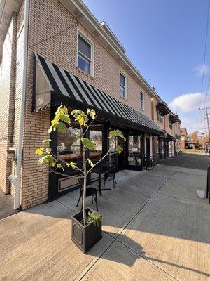 Front view of the coffee shop. The parking lot is to the left of the entrance. You can also park in the front if available.