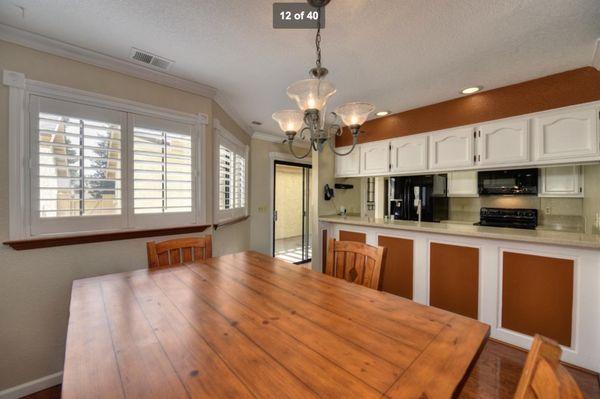 Before. Dated cabinets/countertops. Was claustrophobic feeling.