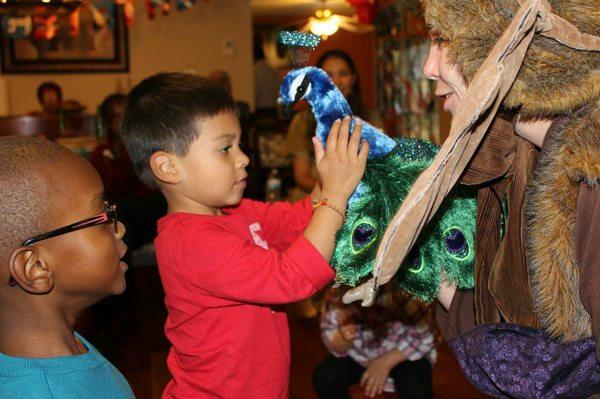 Meeting "Peabody the Peacock" at a living room Birthday Party show.