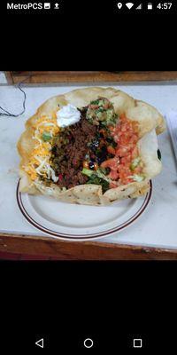 Picture of the beef taco salad made out of a large burrito tortilla. Is taco salad is double the size of a regular taco salad.