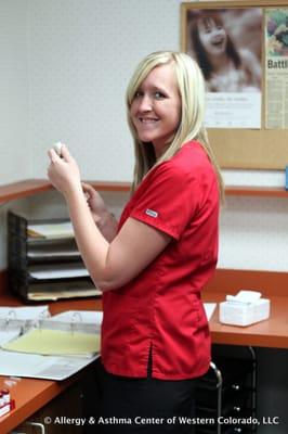 Alica carefully preparing a dose of allergen immunotherapy.