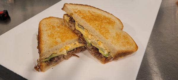 Street Corn Sammy - braised pork, pepper-jack, spicy corn & pepper spread, sliced avocado on sourdough