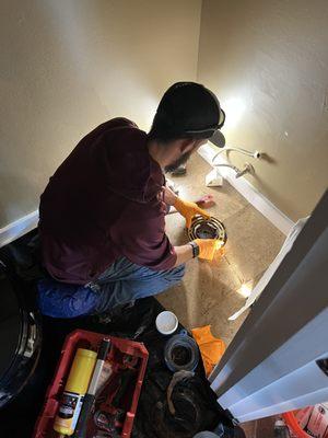 Reliant Plumber installing a new wax ring for a toilet.