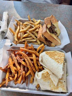 Club wrap with sweet potato fries and Philly with fries.