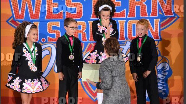 Patricia Kennelly congratulating her under 10 4 Hand team. 1st place in the Western Region!