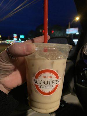 Iced vanilla oat milk latte with caramel sauce.