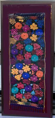 Large Mexican hand made tapestry, mounted on maroon suede backing with fringe showing.