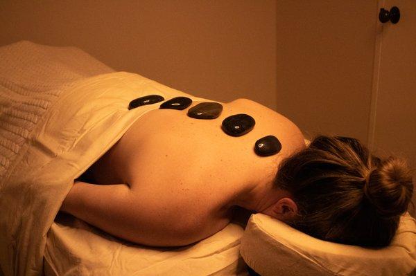 Book an appointment today for a Hot Stone Massage. This service helps with troubled tension spots and reduce stress.