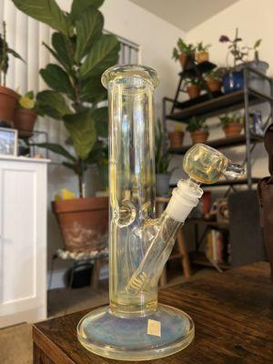 Straight tube water pipe with ice catcher that's helps minimize our coughing. Has a really cool blue and yellow tint in the glass