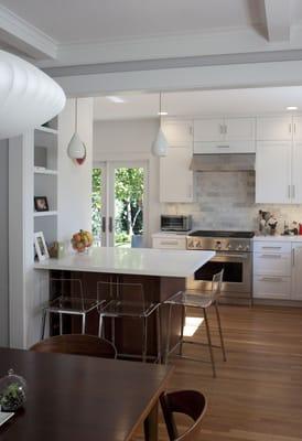 White kitchen cabinets and walnut peninsula by West End Wood Products