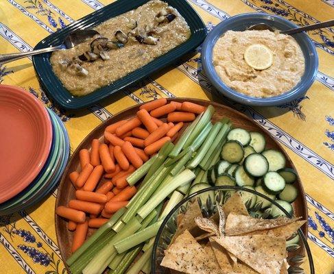 Mezze platter with smoky baba ghanouj, preserved lemon hummus, crudités and Za'atar pita chips.
