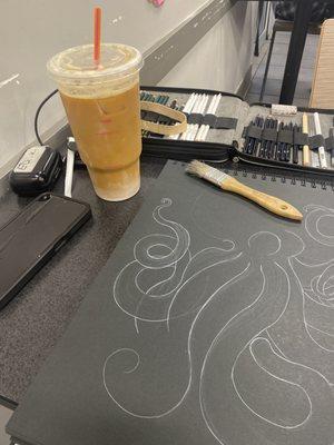My perfectly made iced coffee snd a drawing I'm working on