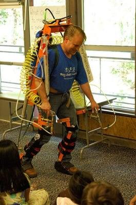 Monty K Reed demonstrating the LIFESUIT robotic exoskeleton for 3rd graders.