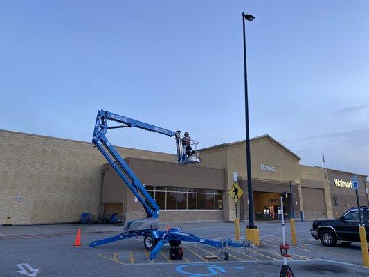 Installing a parking lot light at the Mocks Corner Walmart.