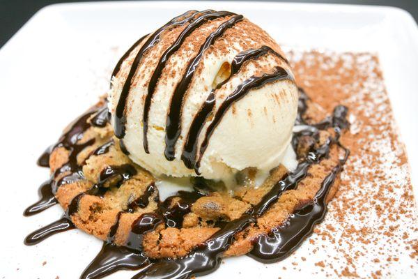 Vanilla ice cream served on a warm chocolate chip cookie.