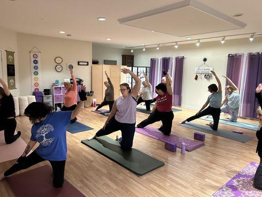 Yoga teacher offers student modifications in beginners Yoga class in Southern Maryland.