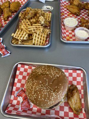 Three enormous Roku TVs lined the wall in front of me. Their sizes were almost frightening.