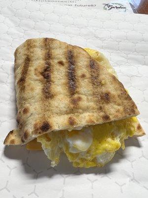 Egg soufflé with pork sausage, American cheese on a flatbread