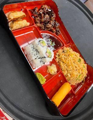$12.50 Lunch special Bento box, 2 pork gyoza, 1 veggie spring roll, 1 cali roll, steamed or fried rice, and choice of protein w/ teriyaki sa