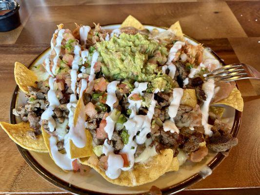 Super Nachos half beef half shredded chicken
