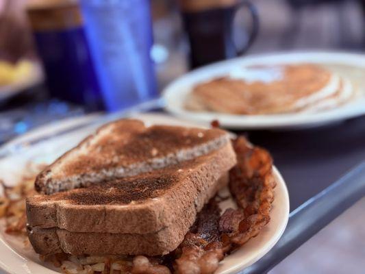 Toast bacon potatoes eggs and pancakes. Yummy