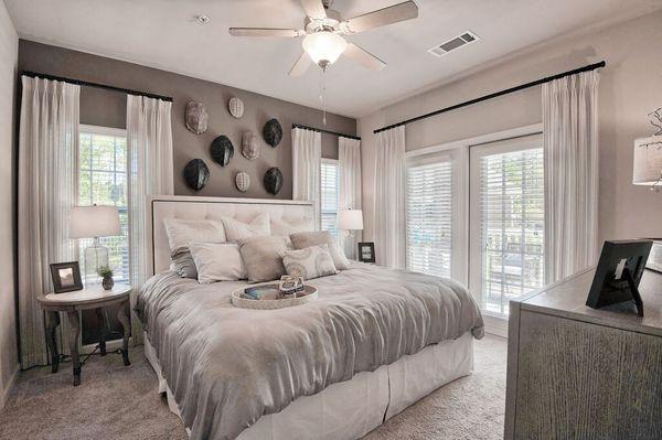 a bedroom with a bed and a ceiling fan at Sterling Creek