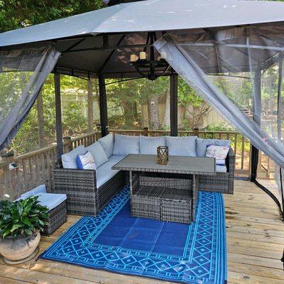 Screened gazebo with comfy seating for hanging out any time of the day or night.