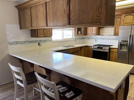 Completed, 3x6 white subway tile with 4" glass inlay.