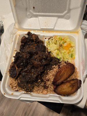 Oxtails, cabbage, rice and beans and plantains