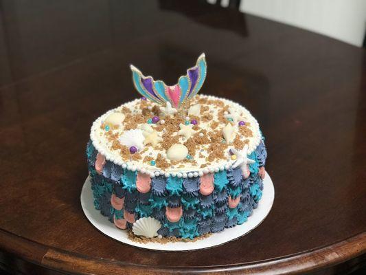 3 layers of white wedding cake, vanilla buttercream mermaid decorations