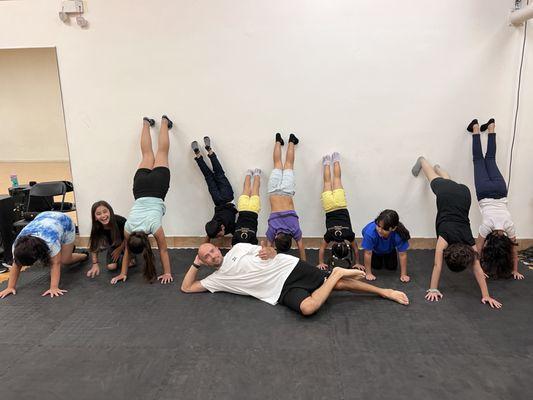 The children have learned to stand on their hands