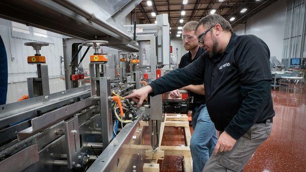 SIGMA Shop techs inspecting equipment. Our shop services can get your machines up and running.