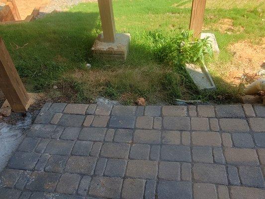 The incomplete job of the pavers 1/3 of the way under the deck.