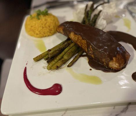Salmon with Mole sauce yellow rice and grilled asparagus