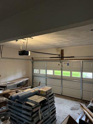 One of the two springs above the center of the door had broken, so Mike came out and replaced them with 25,000 cycle springs.