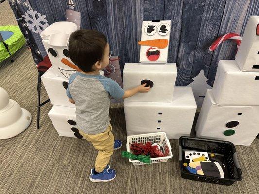 The back decorated for Christmas. Velcroing the snowman's pieces on.