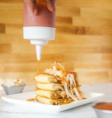 Pupusas served with traditional red sauce and pickle cabbage!