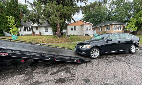 loading a car on to the flatbed tow truck