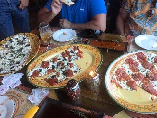 Three pizzas. White pizza has crimini mushrooms and truffle oil. Amazing.