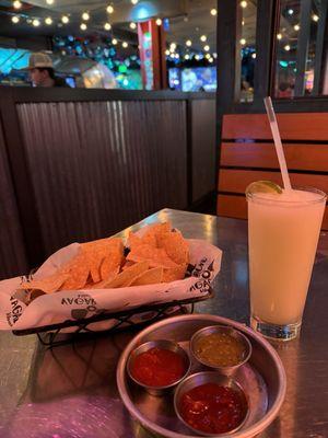 A beautiful blended margarita with chips and salsa
