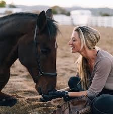 Hatha Equus Founder Elizabeth Riecks bonding with her previously wild Mustang Riggins