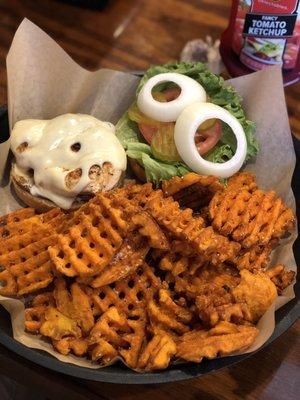 Chicken breast sandwich with Swiss cheese and sweet potato waffle fries.